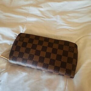 Louis Vuitton Zippy Wallet in the signature Damier Ebene canvas